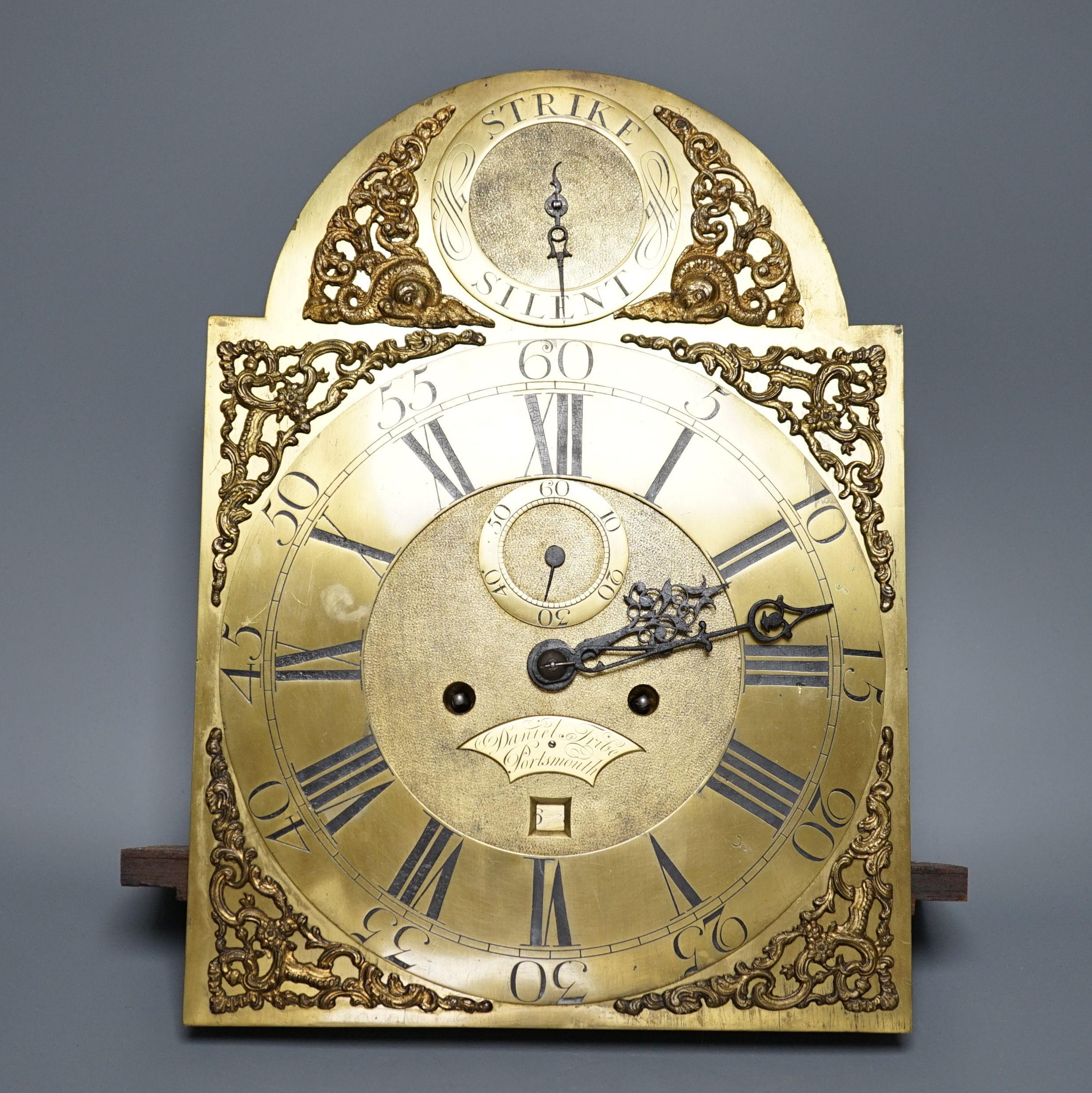 A George III 8-day arched brass dial and five pillar movement, signed Daniel Tribe, Portsmouth, no key or pendulum.